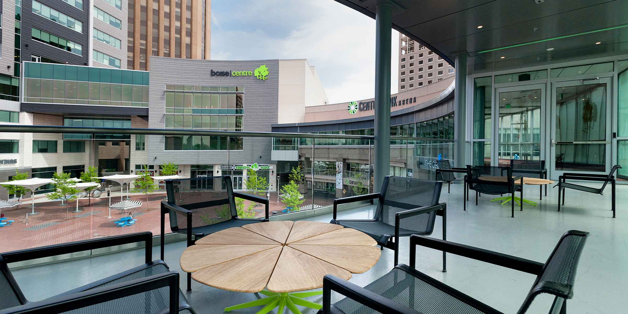 Modern patio table and chairs overlooking Centurylink Arena and Grove Plaza